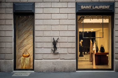 Milan, İtalya - 2026, 13 Ocak: Lüks bir alışveriş bölgesinde şık mermer aksanları, altın aksesuarları ve modern minimalist tasarımı olan şık Saint Laurent FW25 butik vitrini