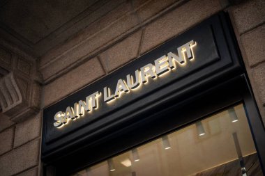 Milan, İtalya - 2026, 13 Ocak: Lüks bir alışveriş bölgesinde ışıklı tabela, modern mimari ve lüks moda cazibesine sahip zarif Saint Laurent FW25 butik mağazası