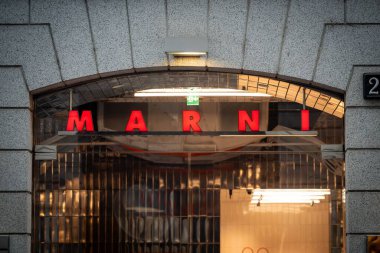 Milan, İtalya - 2026, 3 Şubat: Marni FW25 butik girişi Cesur kırmızı tabela, modern mimari ve lüks bir alışveriş bölgesinde şık kentsel cazibe