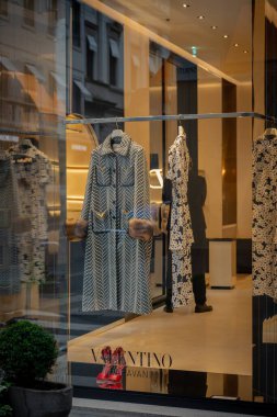 Milan, İtalya - 2026, 3 Şubat: Valentino FW25 butik vitrininde kürk manşetli şık bir tasarımcı ceketi, lüks moda ve modern İtalyan zarafeti sergileniyor