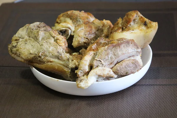 Homemade roasted meat with spices. Pieces baked in oven until golden and crispy, look delicious.
