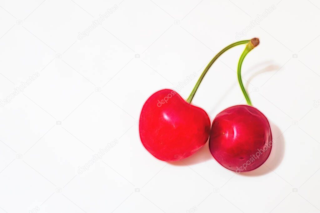 close up red cherries on white plate