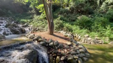 Şelale ve su doğada kayaların üzerinde akıyor.