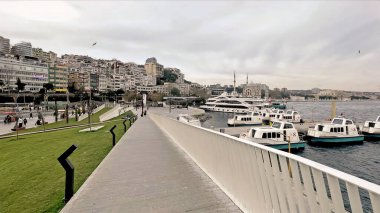 İstanbul, Türkiye. 5 Aralık 2025. İstanbul 'daki Kabatas Feribot Terminali ve Boğaz Sahil Hattı. Kabatas rıhtımında feribotları kenetlenmiş modern yaya geçidi. Yeni yenilenmiş Kabatas kıyı şeridi ve yolcu feribot merkezinin manzarası..