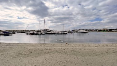 Istanbul,Turkey. March 1,2026. Yesilkoy Coastline, Istanbul. Serene Marmara Sea view with yachts, distant cargo ships, and a cloudy sky. A peaceful seaside landscape in Yesilkoy district, Turkey.
