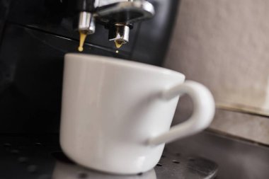 Bir fincana dökülen espresso kahvenin düşük kaliteli fotoğrafı. Kahve hazırlama, sabah rutini, kafein, kafe kültürü ve günlük yaşam tarzı kavramı. Editörel veya gerçekçi içerik için uygun otantik ve kusurlu resim.