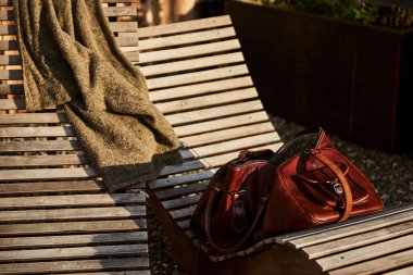 İsviçre 'de bir otelin yanındaki sandalyede dinlenen deri bir çanta. Yanında da deri kaplı bir seyahat defteri. Sahne macera, turizm ve İsviçre 'de şık bir seyahat yaşam tarzını çağrıştırıyor. Seyahat kavramları ve Avrupa turizmi için uygundur