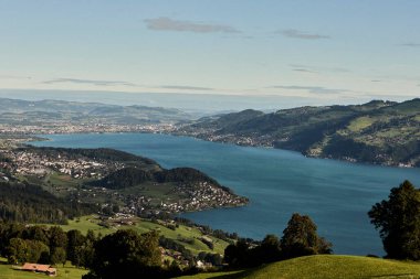 Yeşil dağ manzaraları, dağ zirveleri ve açık gökyüzünün yer aldığı İsviçre Alpleri 'nin yaz manzarası. Görüntü, seyahat, turizm, yürüyüş ve Avrupa doğa kavramları için uygun, doğal güzellik, sükunet ve açık hava macerası taşır..