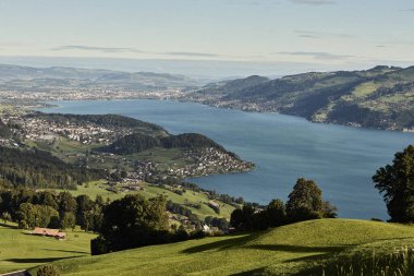 Yeşil dağ manzaraları, dağ zirveleri ve açık gökyüzünün yer aldığı İsviçre Alpleri 'nin yaz manzarası. Görüntü, seyahat, turizm, yürüyüş ve Avrupa doğa kavramları için uygun, doğal güzellik, sükunet ve açık hava macerası taşır..
