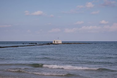 Girit 'in Georgioupoli kentindeki bir rıhtımda duran küçük Agios Nikolaos kilisesi. Çarpıcı tapınak, inancı, kıyı yalnızlığını ve Yunan adalarının eşsiz mimarisini sembolize eder.