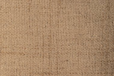 Doğal bej çuval bezi dokusu: kabataslak jüt ya da keten kumaş yüzeyinin kapatılması. Sürdürülebilir, paketlenebilir ve el işi tasarım kavramları için kırsal tuval ayrıntıları.