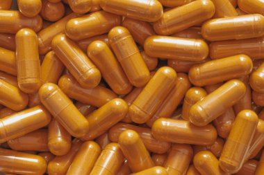 Beyaz mermer üzerine saçılmış parlak curkimin kapsülleri ile en düşük seviyedeki düz yüzey, canlı sıhhatli estetiği ve temiz modern tarzı vurguluyor..