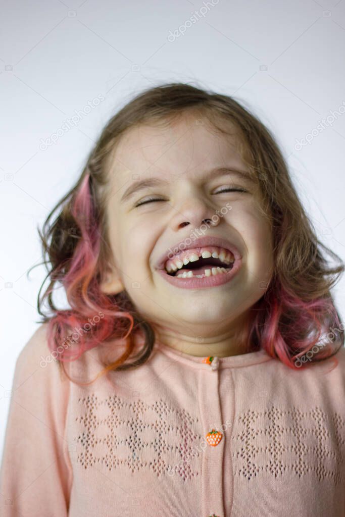 Adorable little kid girl laughing on a white