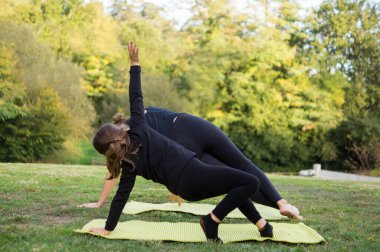 Altı yaşında beyaz bir çocuk yoga atölyesinde esniyor, çocuk sporları konsepti.