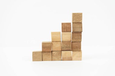 A stack of wooden blocks arranged in a staircase formation, symbolizing growth and progress, set against a clean white background.