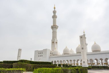 Beyaz bulutlu gökyüzüne karşı Beyaz Cami 'nin minare ve kubbeleri aynı zamanda Şeyh Zayed Büyük Camii olarak da adlandırılır, Pers, Babür ve Fas camii mimarisinden esinlenilmiştir.