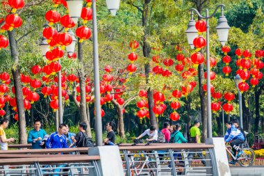 Birçok Çinli hafta sonu boyunca Çin 'in Shenzhen Körfezi' nde geleneksel Çin fenerleriyle parkta yürür..