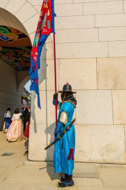 Güney Kore 'nin Seul şehrindeki Gyeongbokgung Sarayı' nın ana girişi olan Gwanghwamun Kapısı 'nda tarihi kostümler içinde kraliyet muhafızlarının savaşçısı.