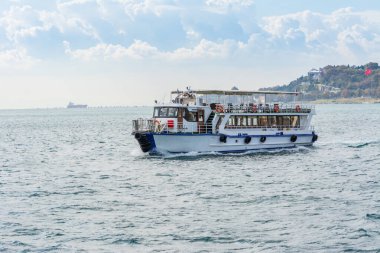 Güneşli bir günde İstanbul, İstanbul ve Türkiye 'nin arka plan bulutlu gökyüzü ile İstanbul Boğazı' nda turist gezisi
