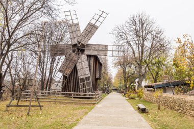 Authentic old wooden windmill from all over Romania in Dimitrie Gusti National Village Museum, an open-air ethnographic museum located in the King Michael I Park, showcasing traditional Romanian village life