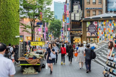 Street view of Myeongdong Shopping Street , mostly a commercial area, being one of Seoul's main shopping, parade route and tourism districts in Seoul, South Korea clipart