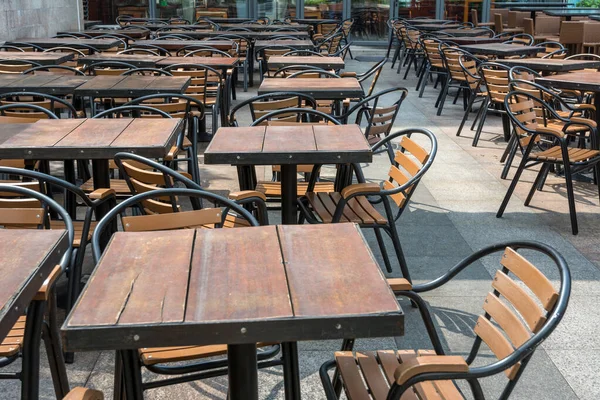 Lost of tables and chairs at restaurant or pub.