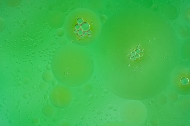 Abstract green bubbles in water, symbolizing environmental purity and fresh natural energy. Clean, horizontal composition, concept of ecology, biotechnology, clean water, and sustainable development.