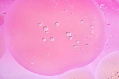 Macro abstract, large and small pink bubbles in water create a soft minimalist background. Smooth color transitions, simple structure, horizontal format