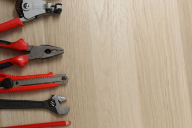Repair tools, plumber, locksmith, electrician on a wooden background