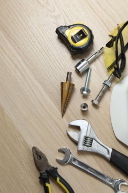 Repair tools, plumber, locksmith, electrician on a wooden background
