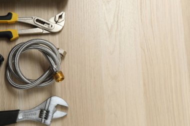 Repair tools, plumber, locksmith, electrician on a wooden background