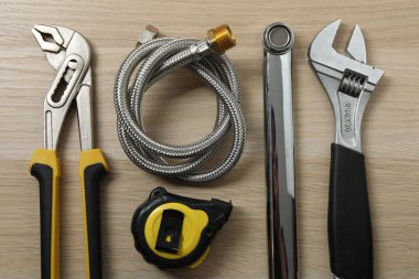 Repair tools, plumber, locksmith, electrician on a wooden background
