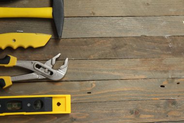 Repair tools, plumber, locksmith, electrician on a wooden background