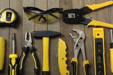 Repair tools, plumber, locksmith, electrician on a wooden background