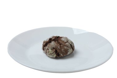 Beyaz arka planda izole edilmiş bir tabakta taze pişmiş çikolata kırışmış kurabiyeler.