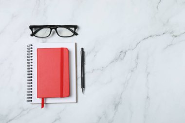 Kalem ve kahveyle masaya yaylı not defteri. Ofis kavramı. Üst görünüm.