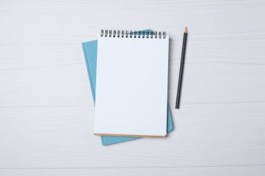 Kalem ve kahveyle masaya yaylı not defteri. Ofis kavramı. Üst görünüm.