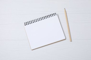 Kalem ve kahveyle masaya yaylı not defteri. Ofis kavramı. Üst görünüm.