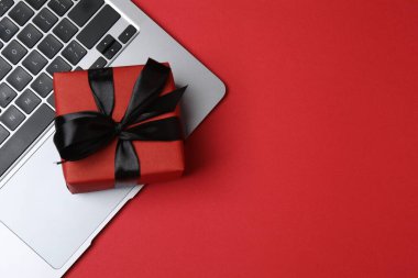 Gift box and laptop on office desk table. Top view flat lay with blank greeting card for your greetings. Valentines day
