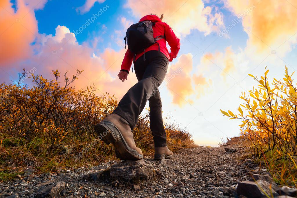 View of Woman Hiking Rocky Trail from Below