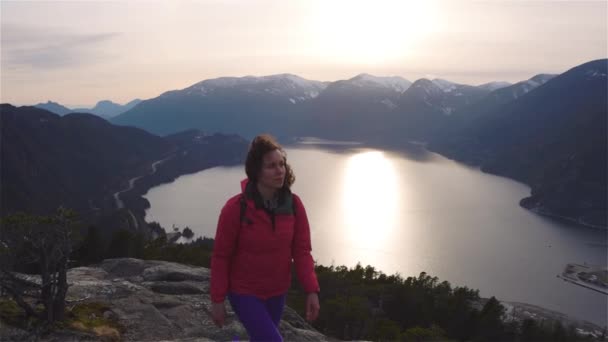 Chica aventurera Senderismo en la cima de un pico — Vídeo de stock