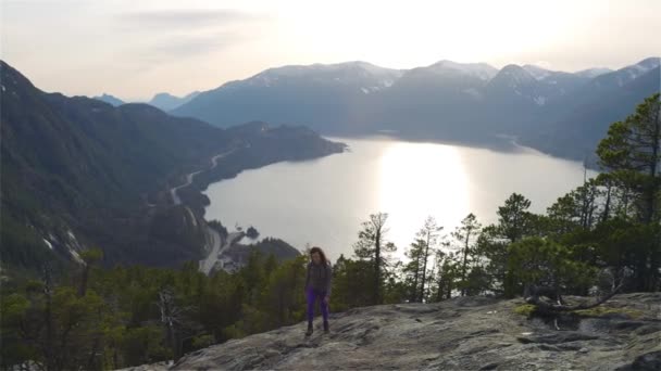 Chica aventurera Senderismo en la cima de un pico — Vídeos de Stock