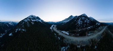 Aerial Panoramic View of a scenic Highway passing in the Canadian Landscape clipart
