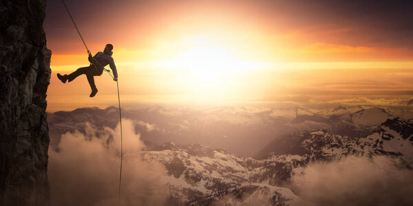 Epic Adventurous Extreme Sport Composite of Rock Climbing Man Rappelling from a Cliff. Mountain Landscape Background from British Columbia, Canada. Concept: Explore, Hike, Adventure, Lifestyle