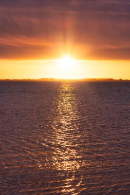 Beautiful View of colorful cloudscape over the ocean during dramatic sunset