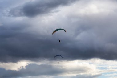 Maceracı Adam dağların etrafında bir paraglider üzerinde uçuyor..