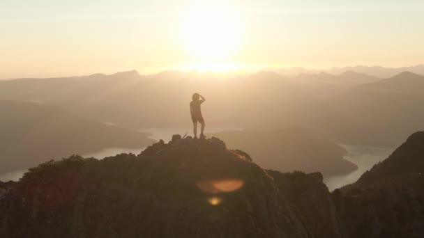 Mulher caucasiana aventurosa Caminhadas no topo de um penhasco de montanha rochosa. — Vídeo de Stock