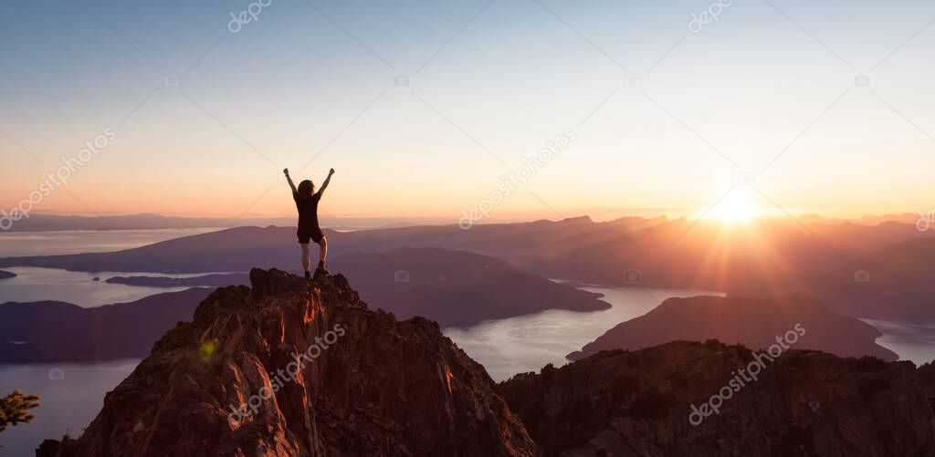 Adventurous Caucasian Woman Hiking on top of a Rocky Mountain Cliff.