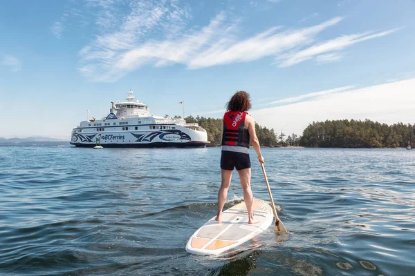 Adventurosa mulher paddle embarque perto BC Ferries Barco em Swartz Bay — Fotografia de Stock