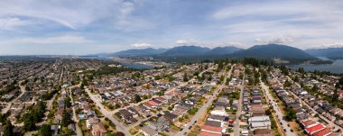 Burnaby 'nin panoramik kuş bakışı manzarası, sergilenen evler, şehir manzarası ve çarpıcı bir dağ manzarası..